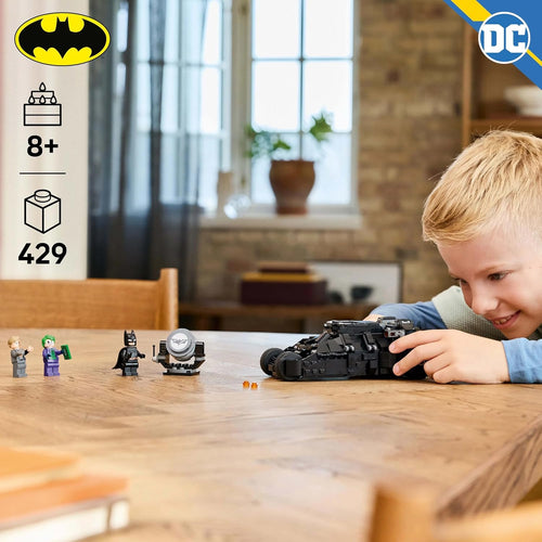 Child playing with lego dc batman tumbler vs the joker and two face