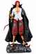 A detailed collectible figurine of Shanks, standing on stone with sword and his cape 